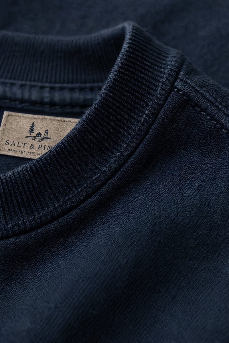 Close-up of a navy heavyweight tee with a ribbed crew neck and Salt & Pine label